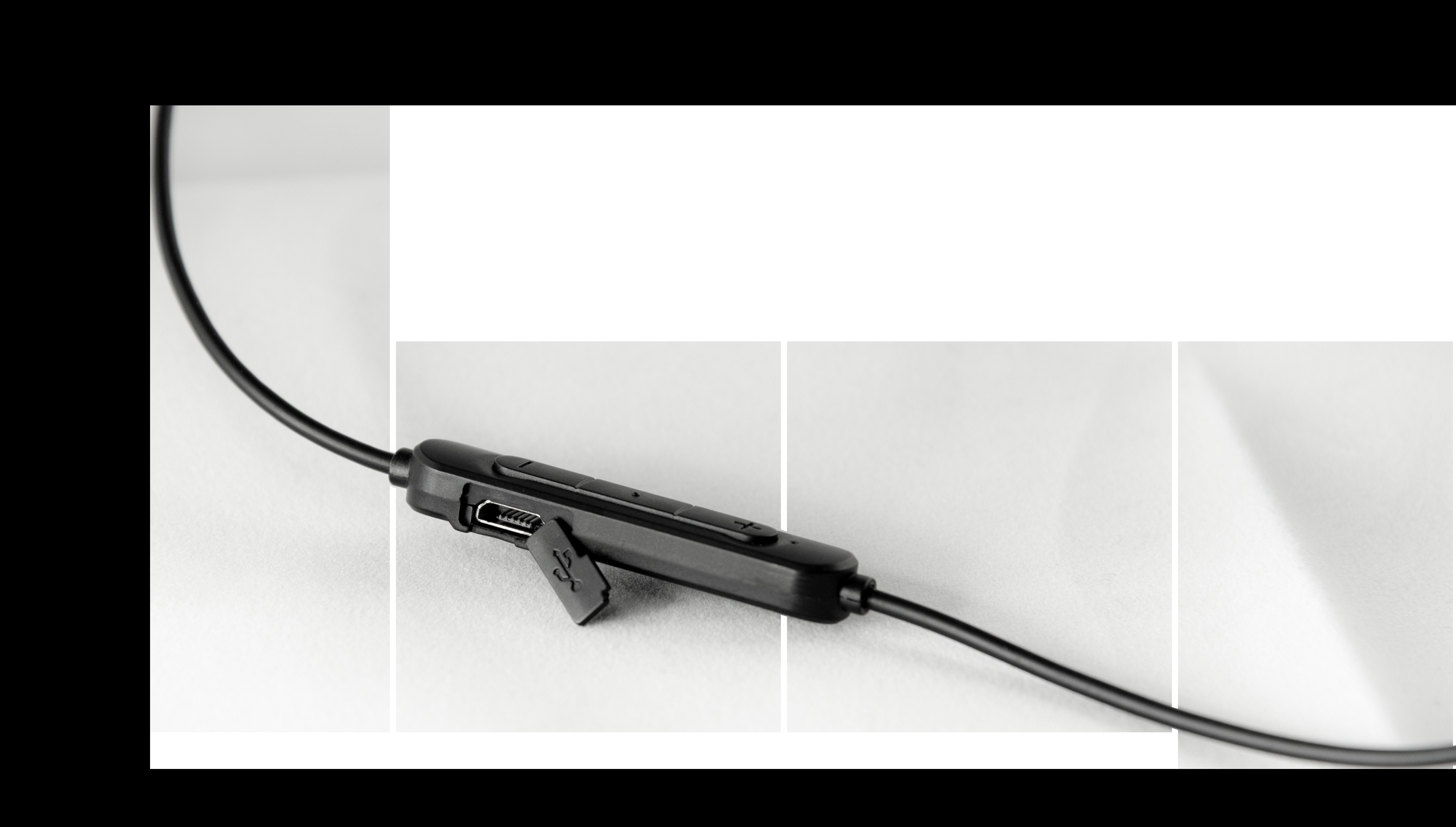 Schwarze In-Ear-Kopfhörer mit Bedienfeld und Ladeanschluss. Weißer Hintergrund.
