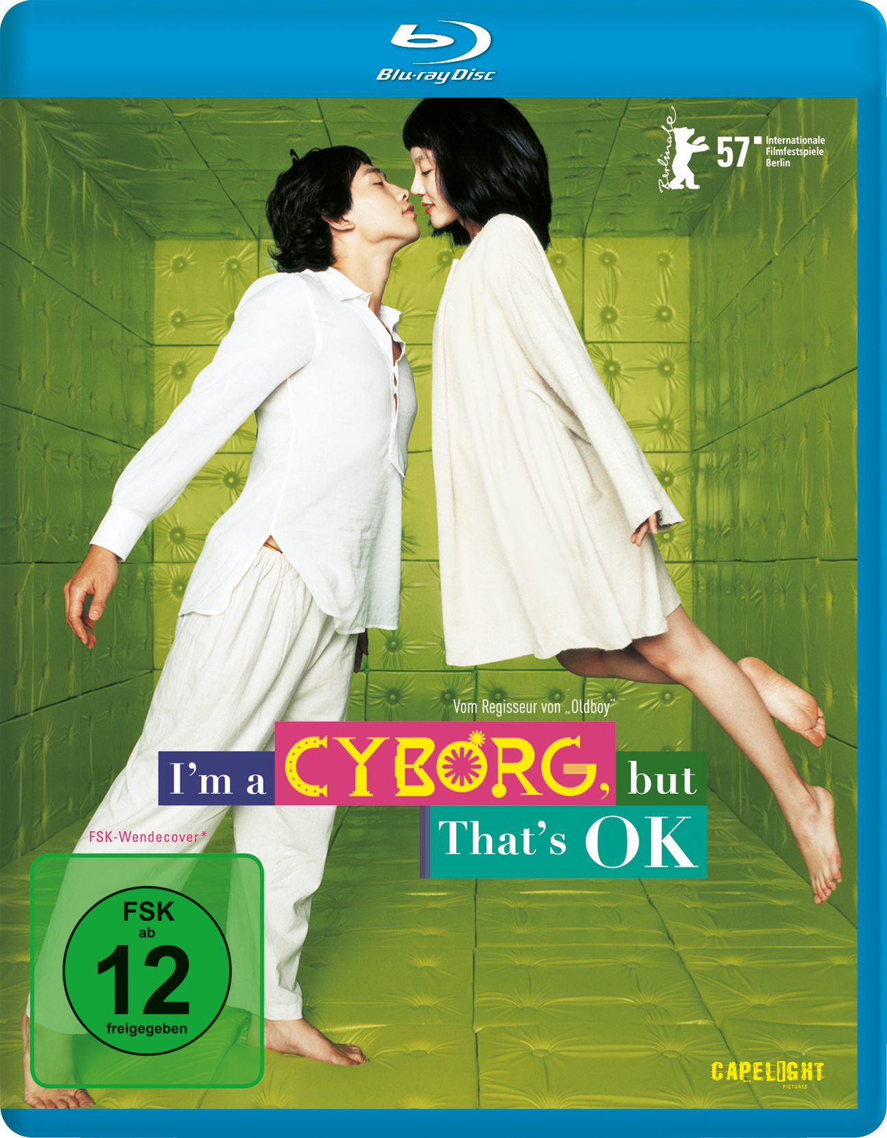 DVD-Cover von 'I'm a Cyborg, But That's OK'. Zwei küssende Personen, grüner und violetter Hintergrund.