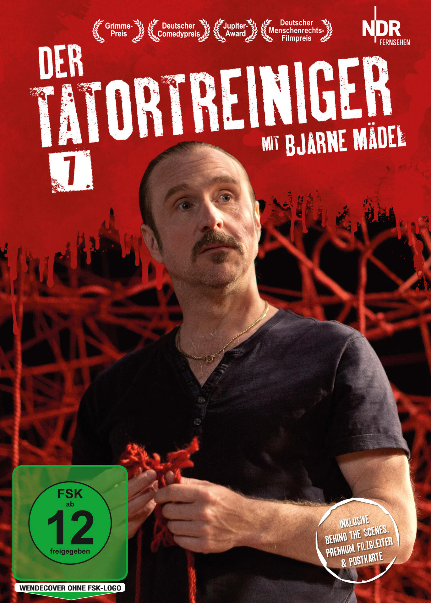 DVD-Cover, Mann mit Schnurrbart, roter Hintergrund, Text 'Der Tatortreiniger'. Auszeichnungen sind sichtbar. Dunkler Hintergrund.