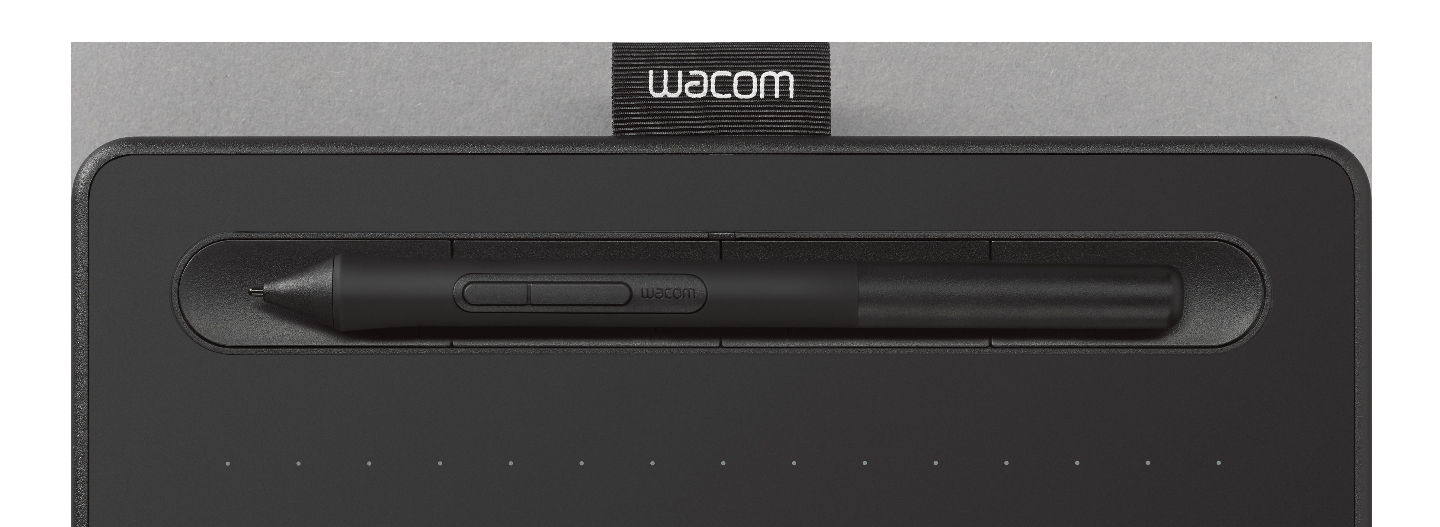 Wacom Zeichentablett und Stift. Schwarzes Tablet und Stift auf grauem Hintergrund. Text: Wacom.