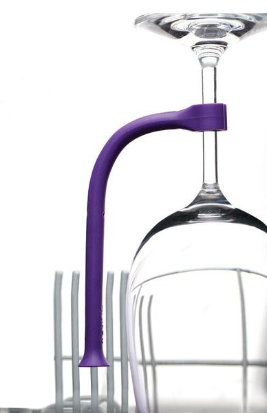 Purple wine glass holder attached to a glass and a drying rack. The holder is curved.