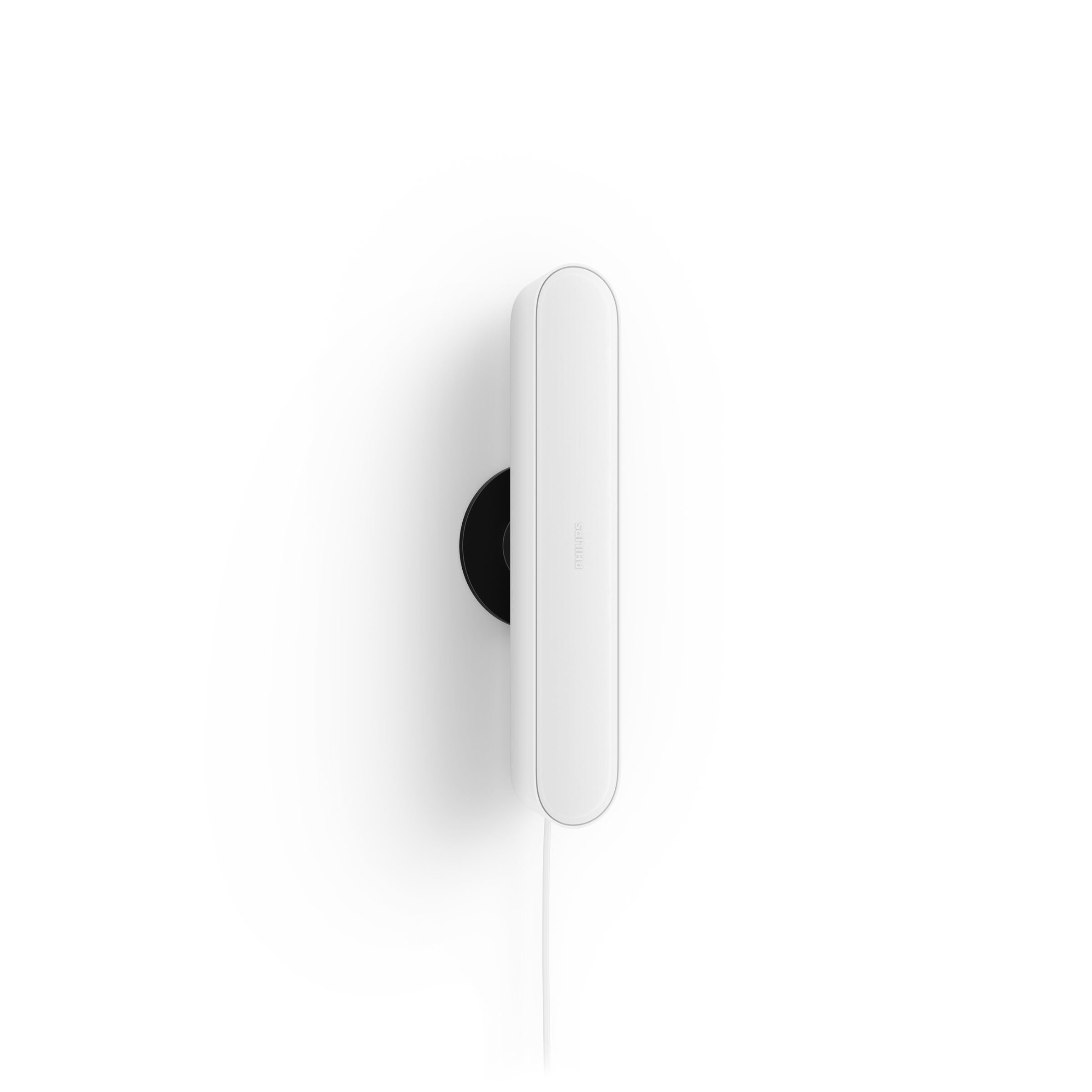 A white, elongated device with a black circular base and a white cable.