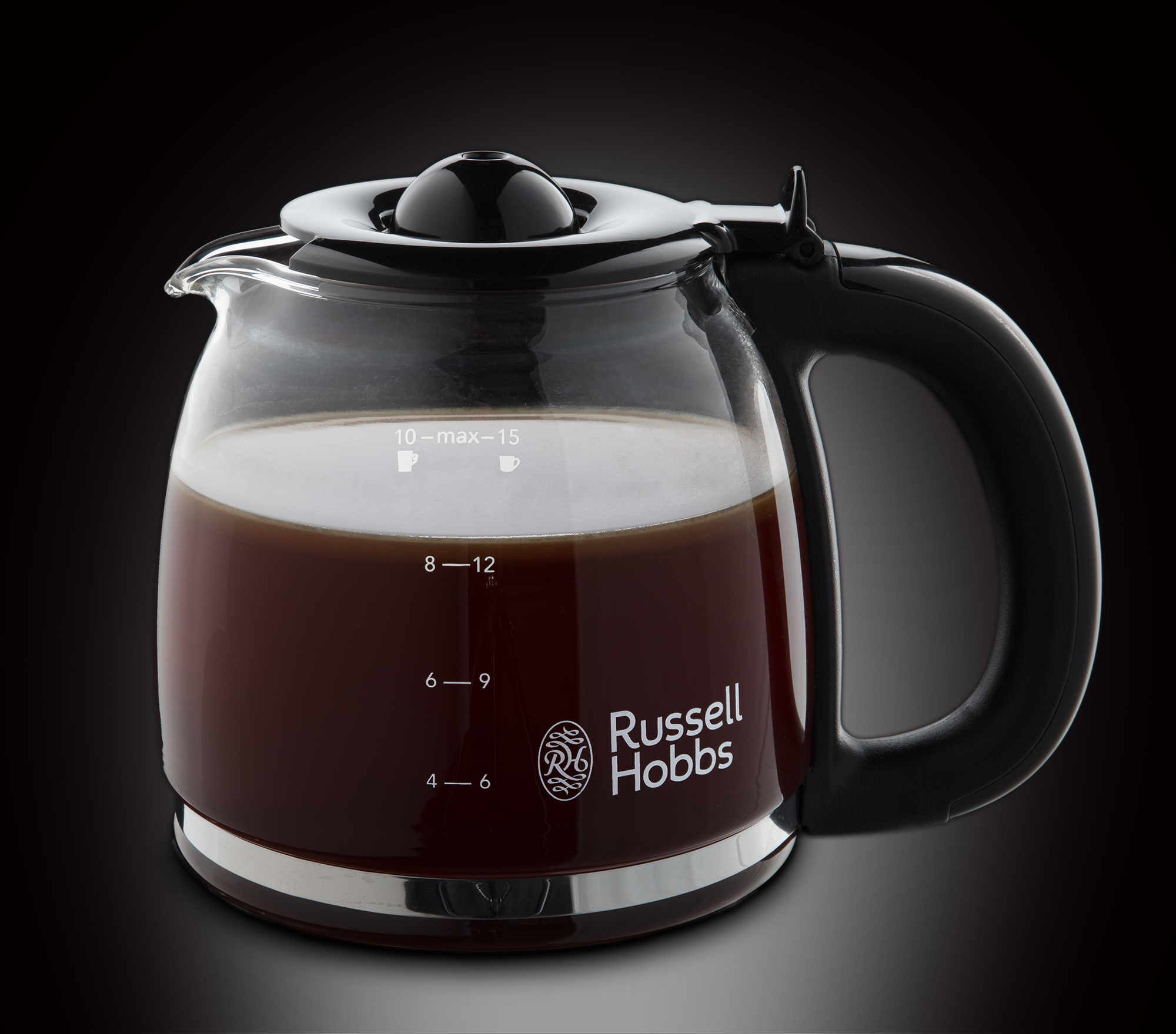 A glass coffee pot filled with dark coffee, showing measurement markings and logo.