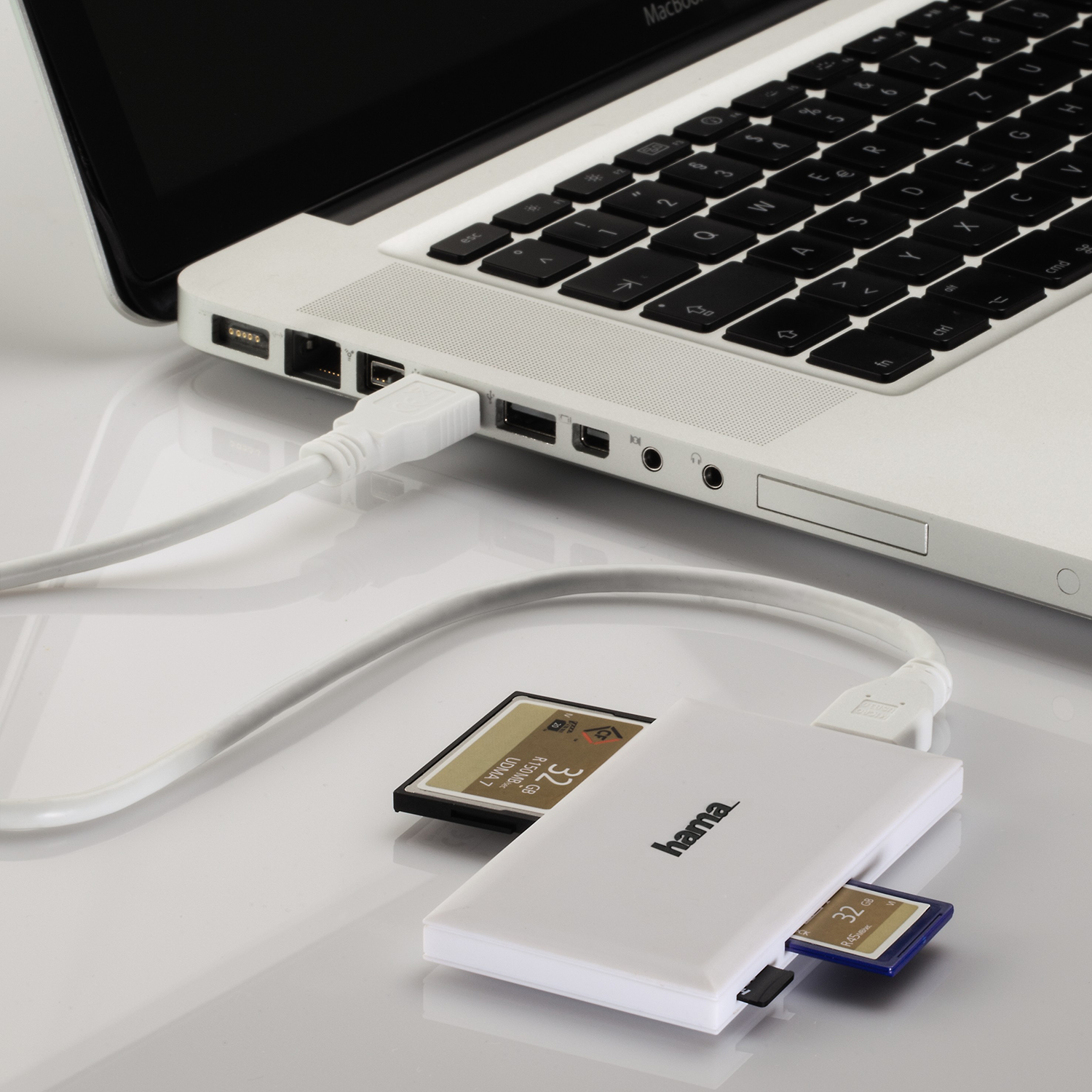 Laptop connected to a card reader with SD and microSD cards inserted.