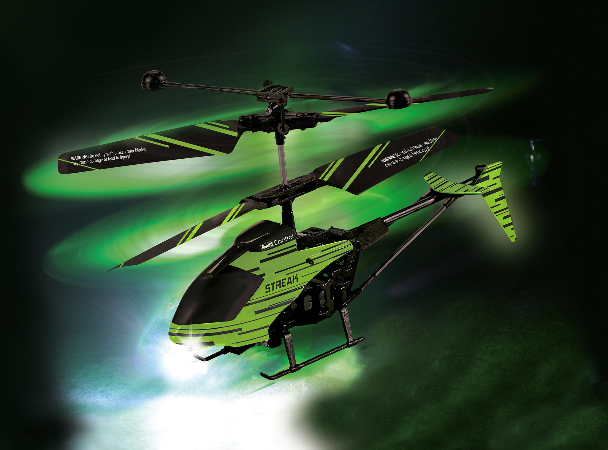 Grüner und schwarzer Spielzeug-Hubschrauber mit sich drehenden Rotorblättern.