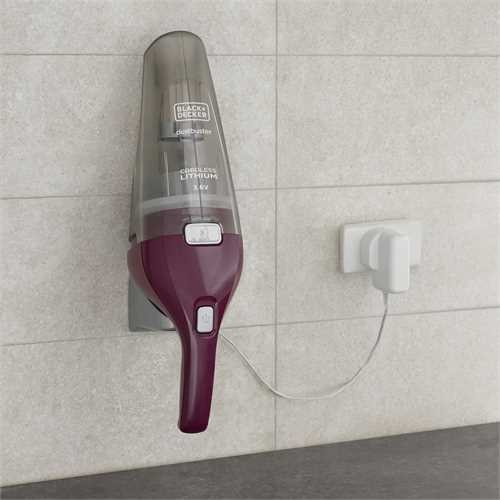 A cordless vacuum cleaner is mounted on a wall next to an electrical outlet.
