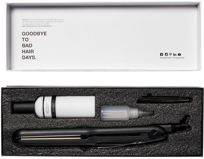 Hair care set in a box. Includes a hair straightener and serum. Background: white.