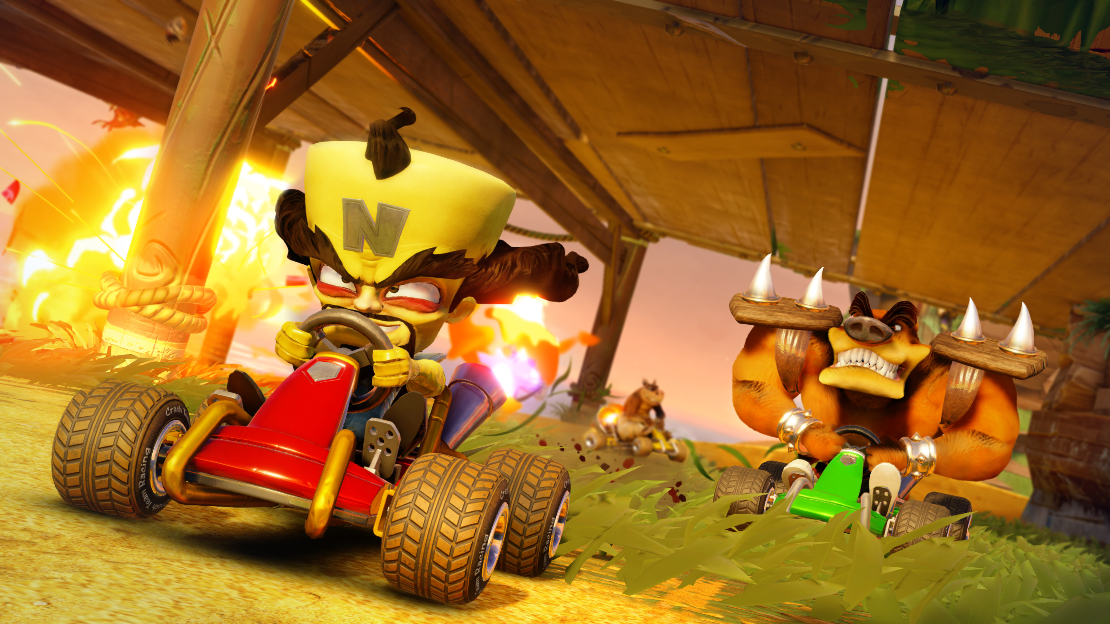 Crash Bandicoot Kart-Rennen mit Charakteren und Explosionen in tropischer Umgebung.