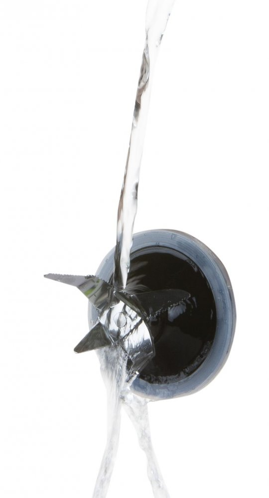 Water pouring into a blender from above, blades visible inside, white background.