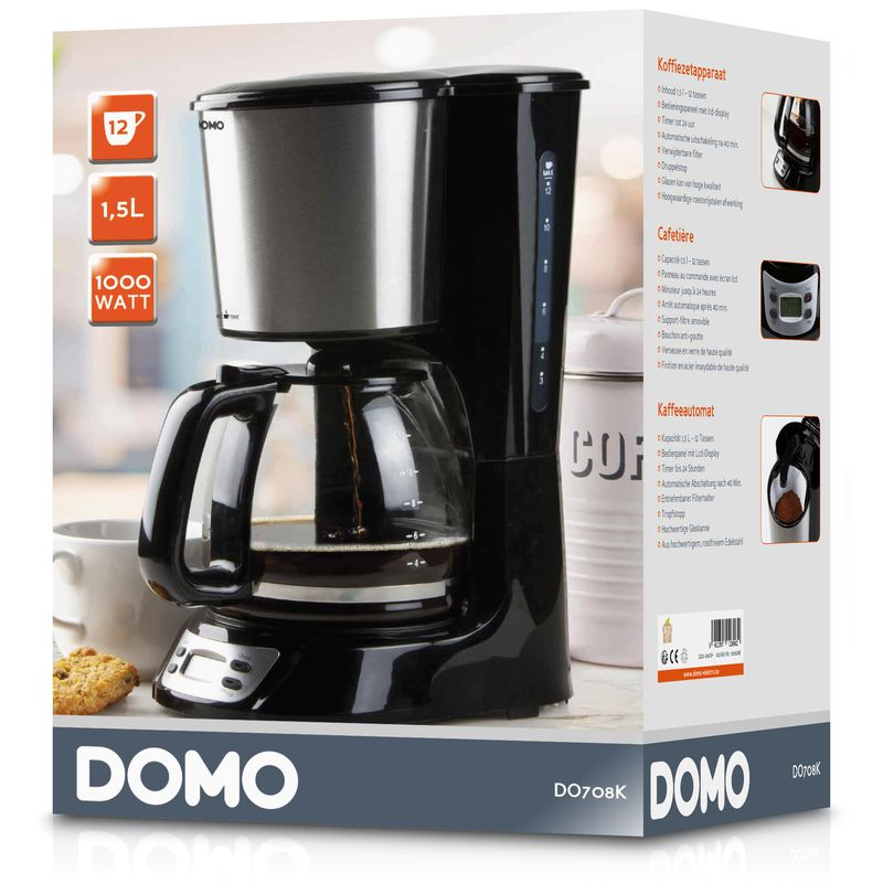 Black and silver coffee maker with glass carafe and box.