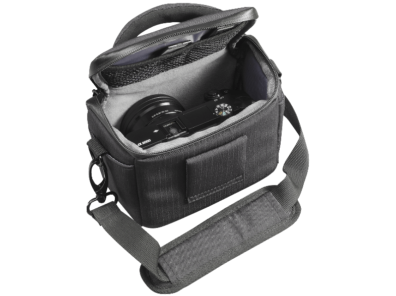 A black camera in a black bag with a shoulder strap. The bag is open.