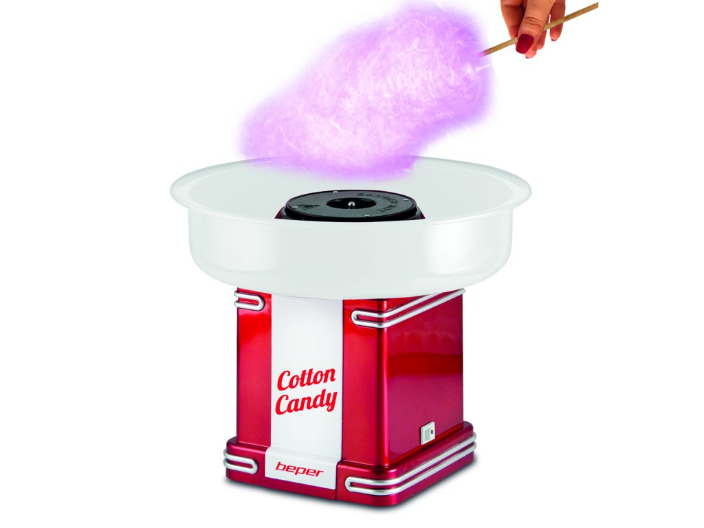 A cotton candy machine, red and white, with cotton candy being spun out by a hand.