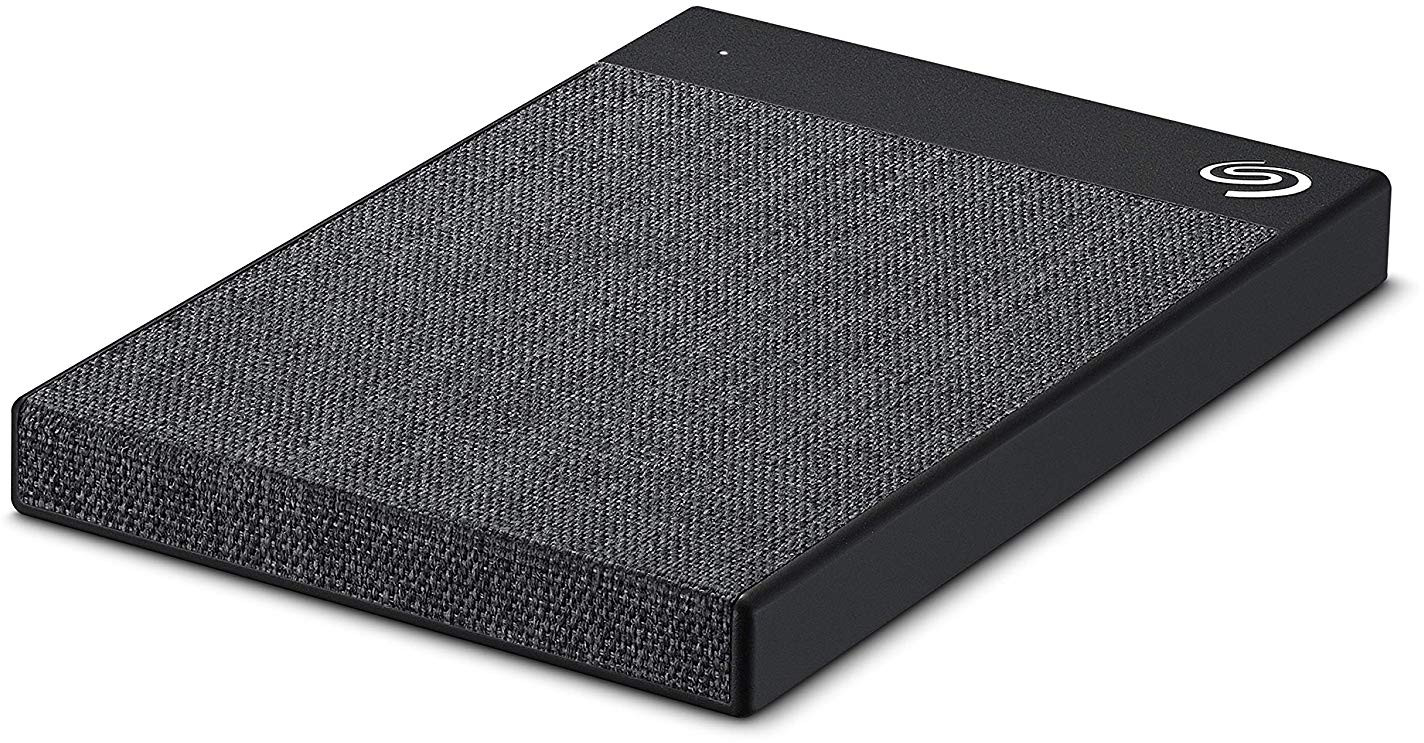 Black external hard drive with a fabric texture top. Seagate brand logo in white.