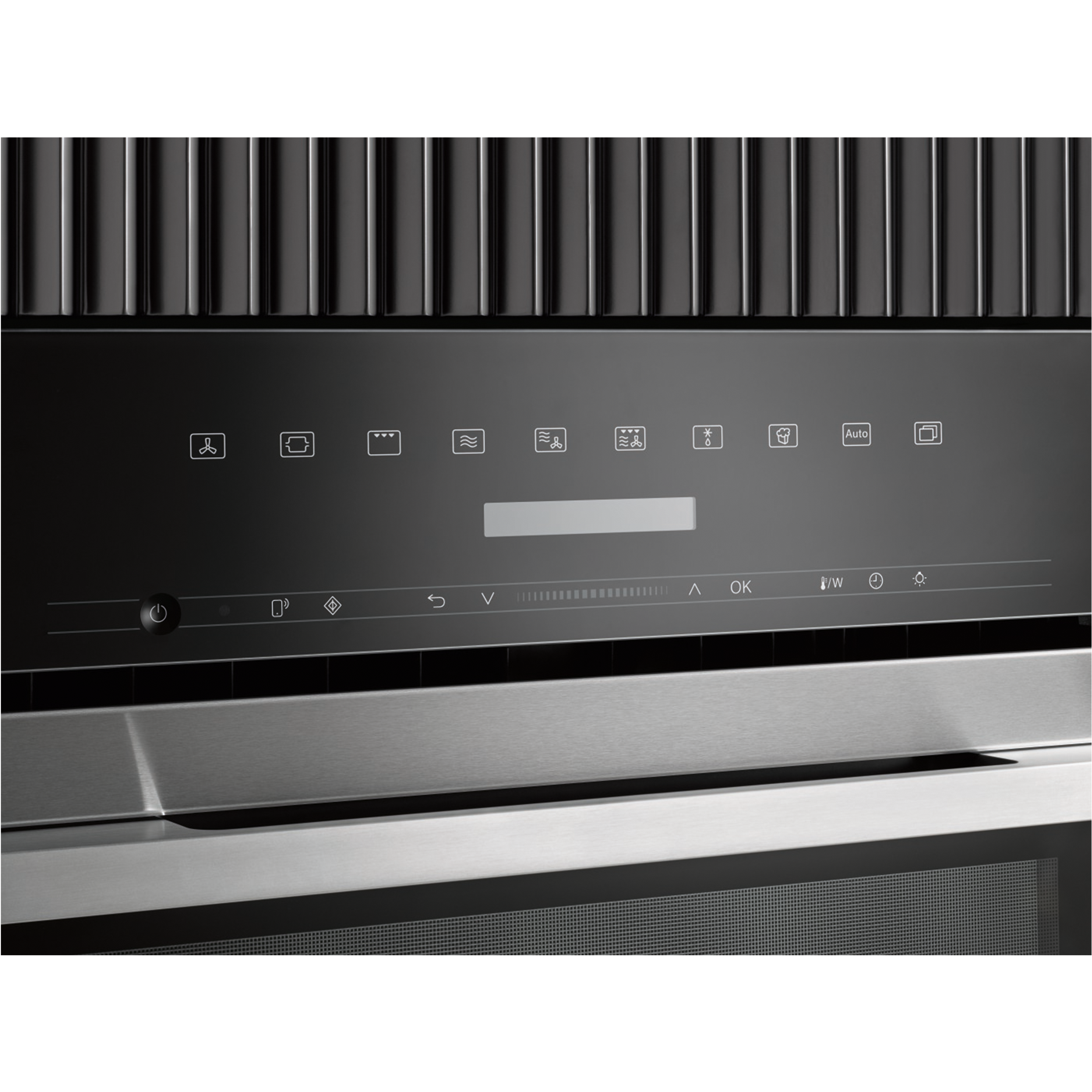 Close-up of a black control panel with icons and a display.