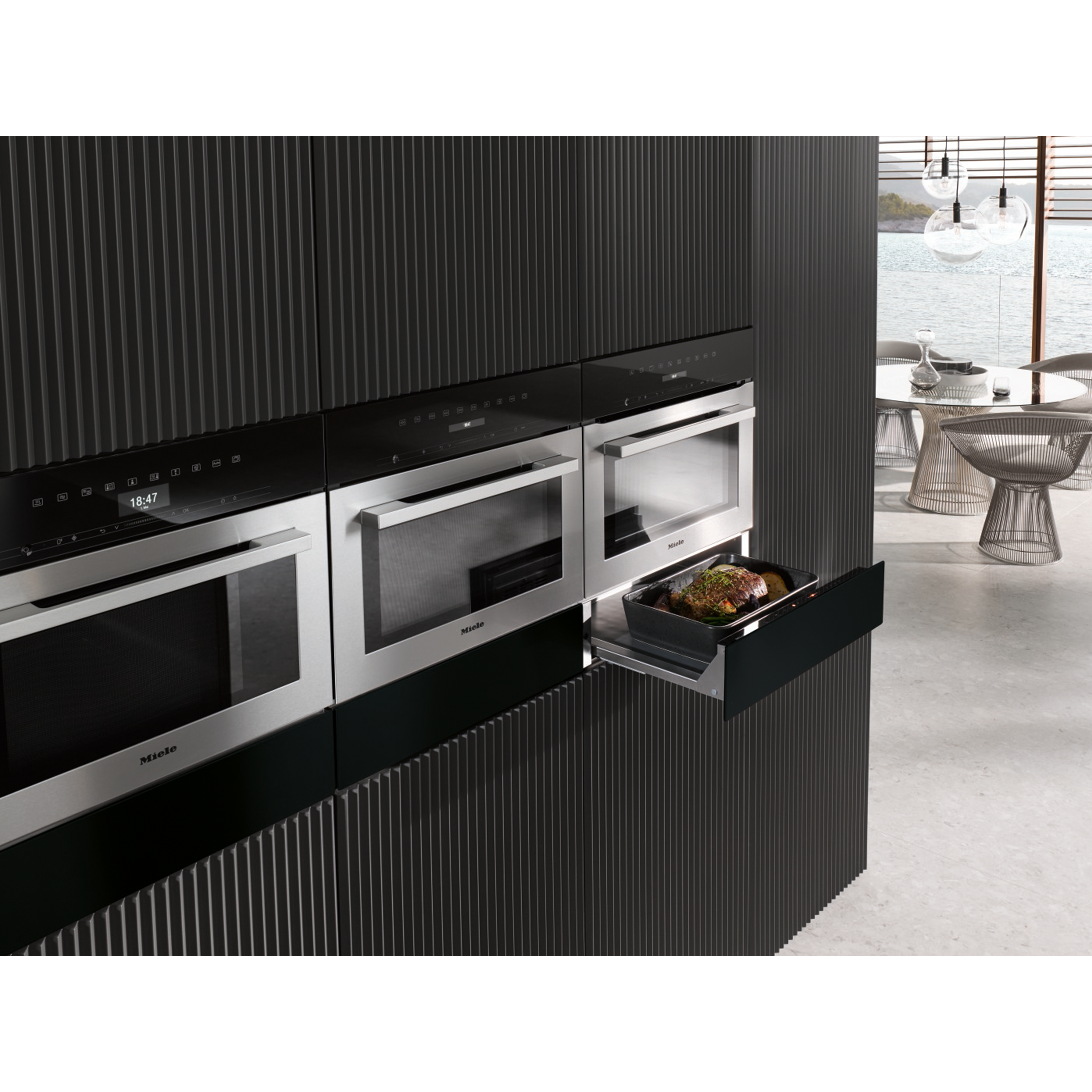 Modern kitchen with Miele appliances, one opened with food.