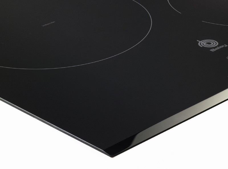 Placa de inducción negra con marcas circulares blancas para zonas de cocción.