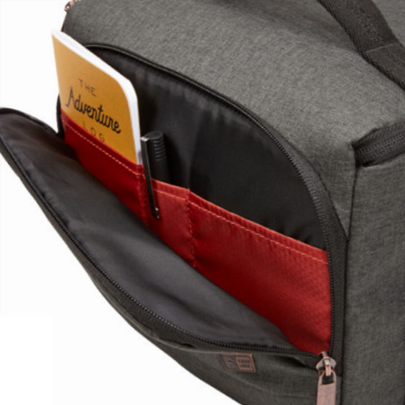 A grey bag with a pocket containing a notebook and pen.