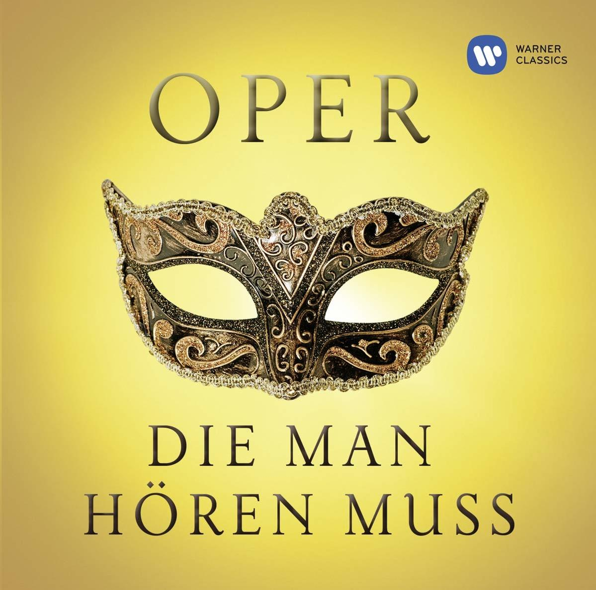 Opernmaske auf gelbem Hintergrund mit Text. Warner Classics Logo oben rechts.