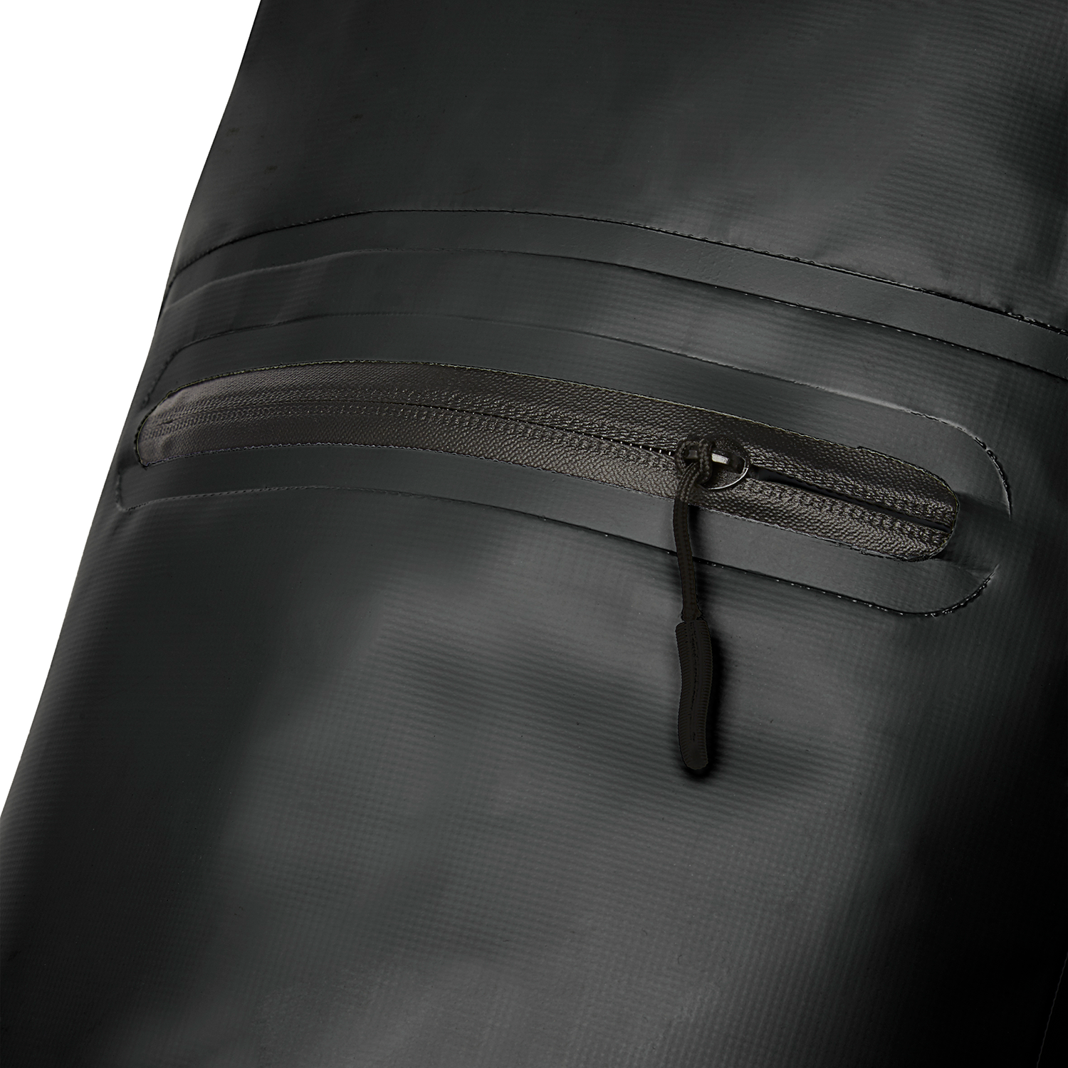 Close-up of black, textured fabric with a zipper pocket. The zipper has a black pull tab, and the fabric has subtle lines.