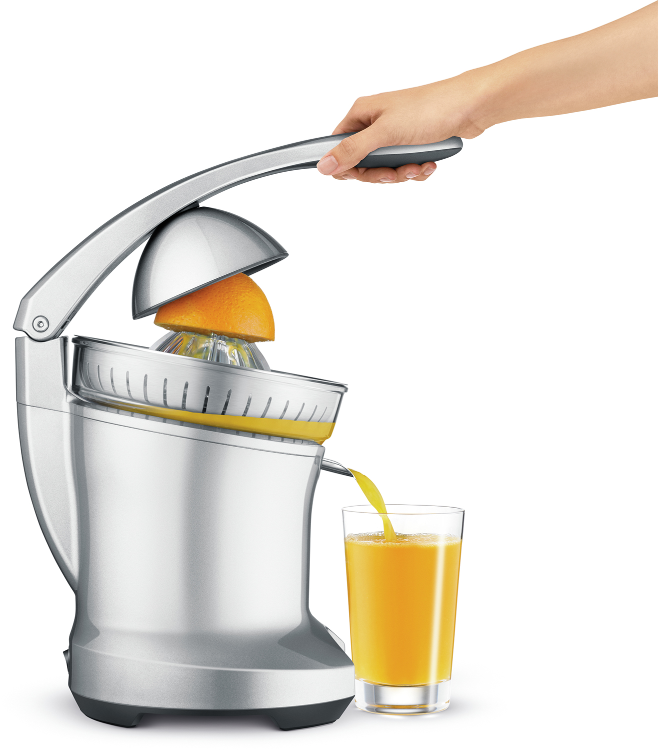 Silver juicer with orange. Hand squeezing juice into a glass.