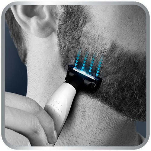 Hombre se afeita la barba con recortadora eléctrica. Líneas azules indican cabello cortado.