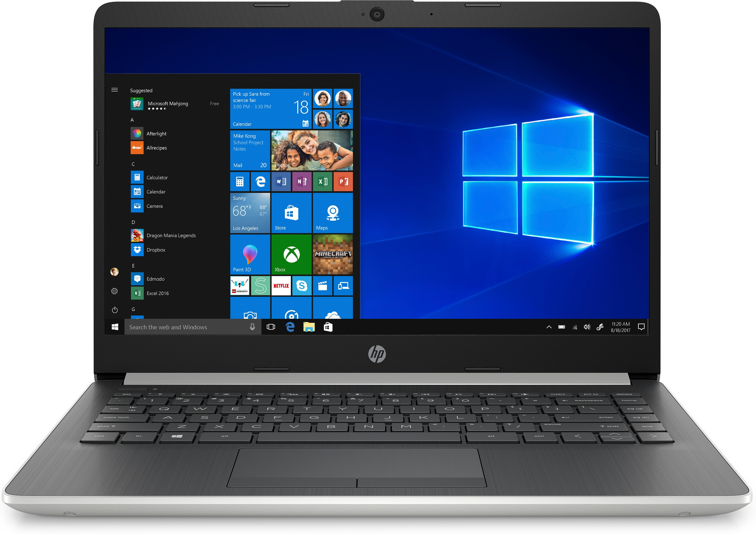 Portátil plateado sobre fondo blanco. Pantalla muestra escritorio Windows con iconos.