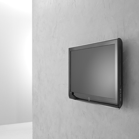 Un televisor de pantalla plana montado en una pared gris texturizada.