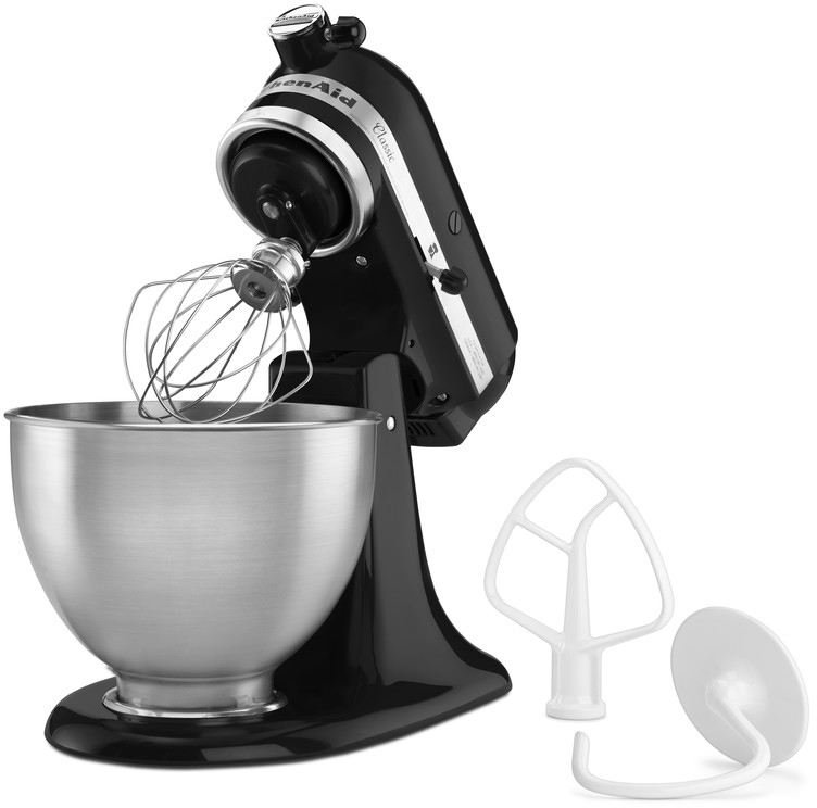 Black KitchenAid mixer with attachments. A stainless steel bowl is below the mixer.