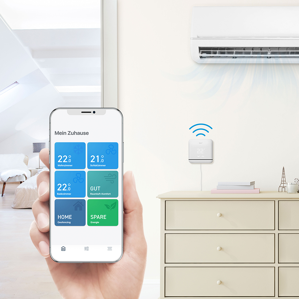 Eine Hand, die ein Telefon hält, das eine Smart-Home-App mit Temperatur- und Energieeinstellungen zeigt.