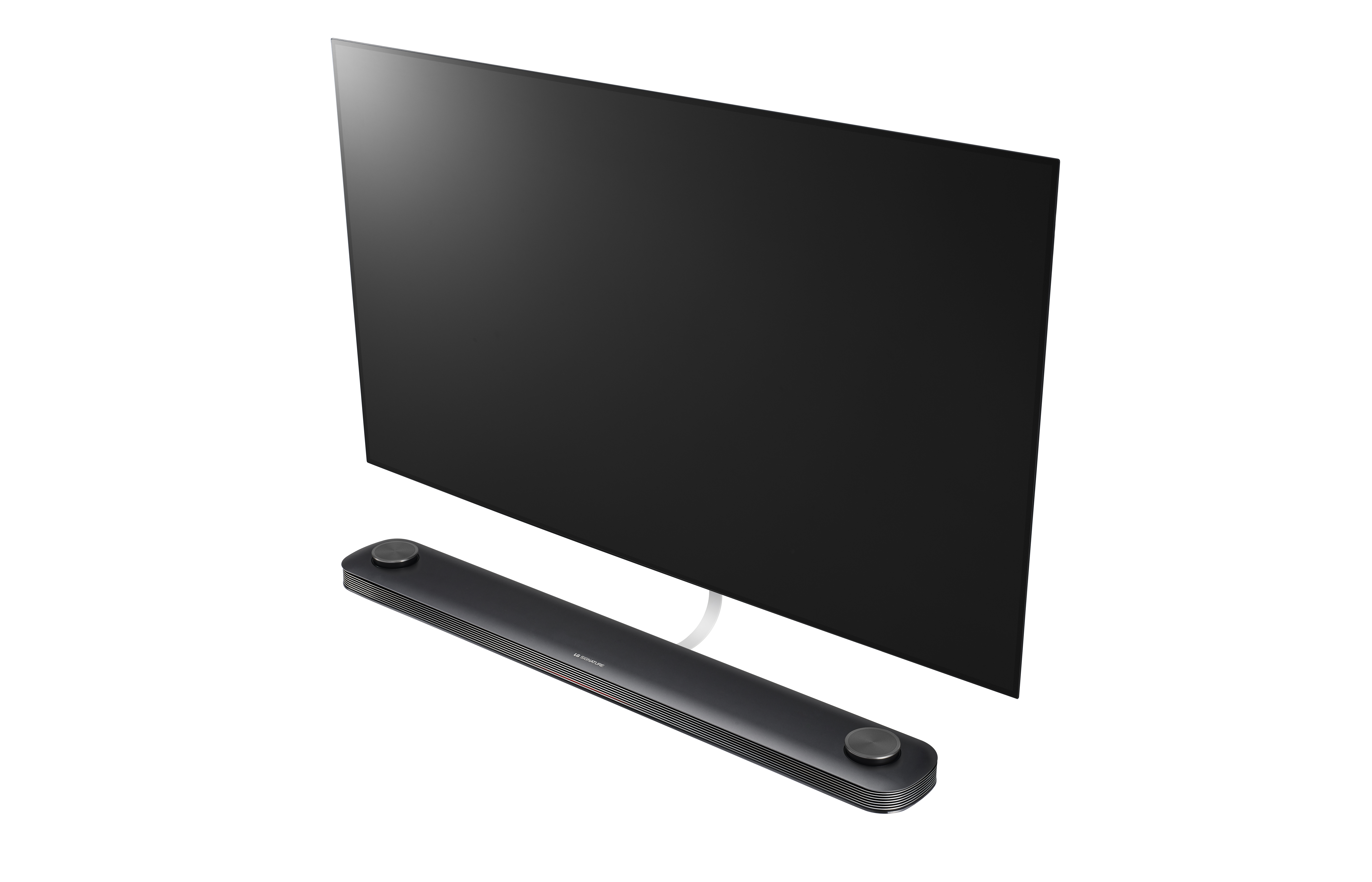 Televisor de pantalla negra grande con barra de sonido. El televisor está sobre una superficie blanca.