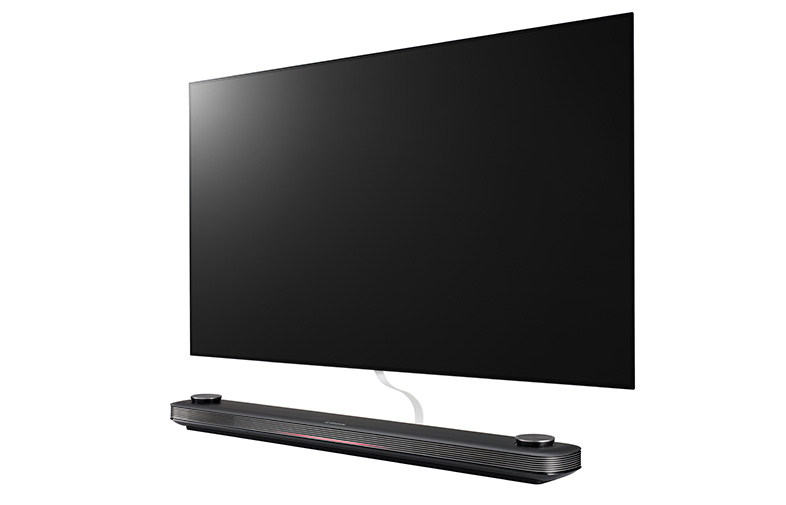 Un televisor LG negro con una barra de sonido. La pantalla es negra. La barra de sonido está debajo del televisor.