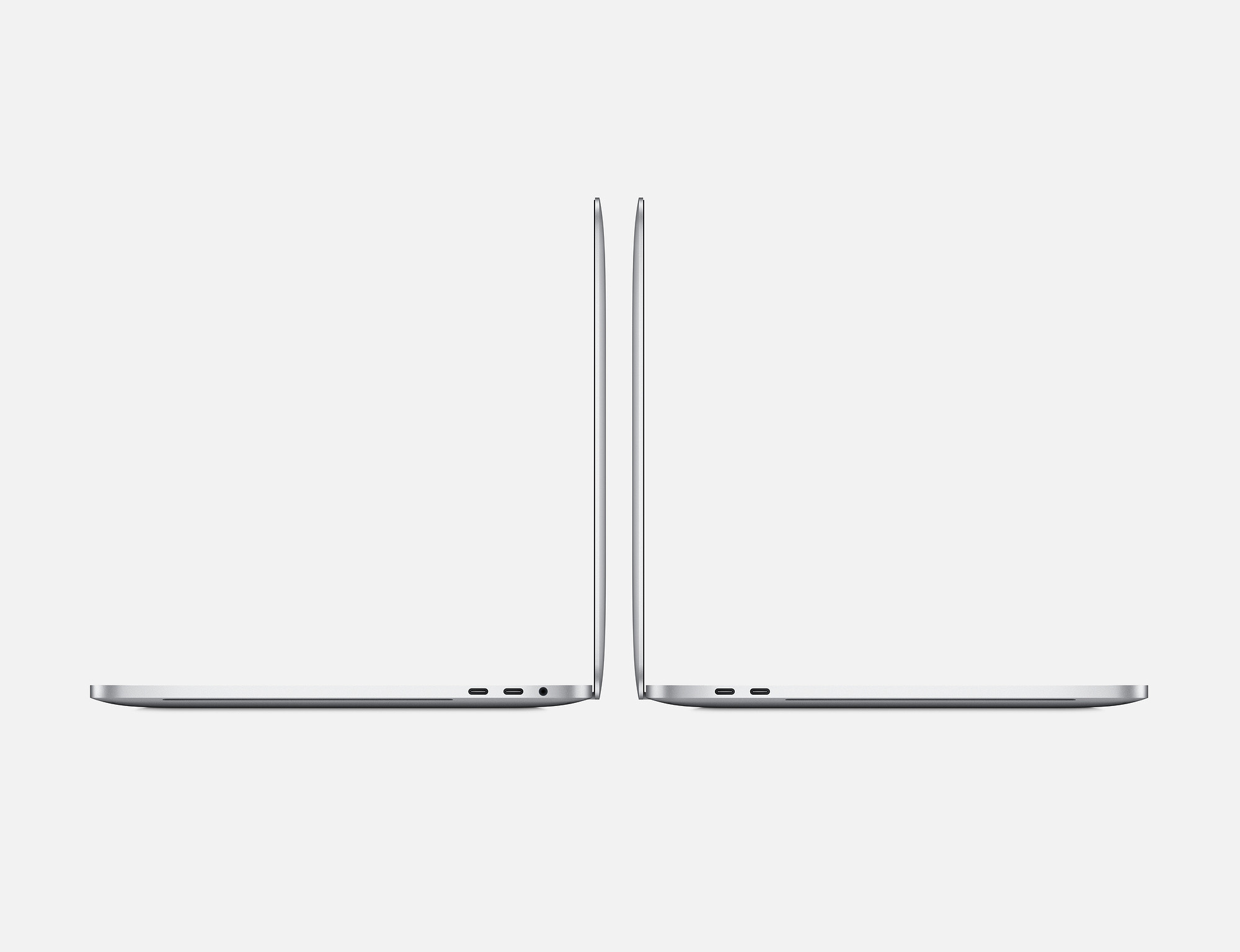 Zwei silberne Laptops Seitenansichten auf weißem Hintergrund. Beide sind geschlossen und zeigen Anschlüsse.