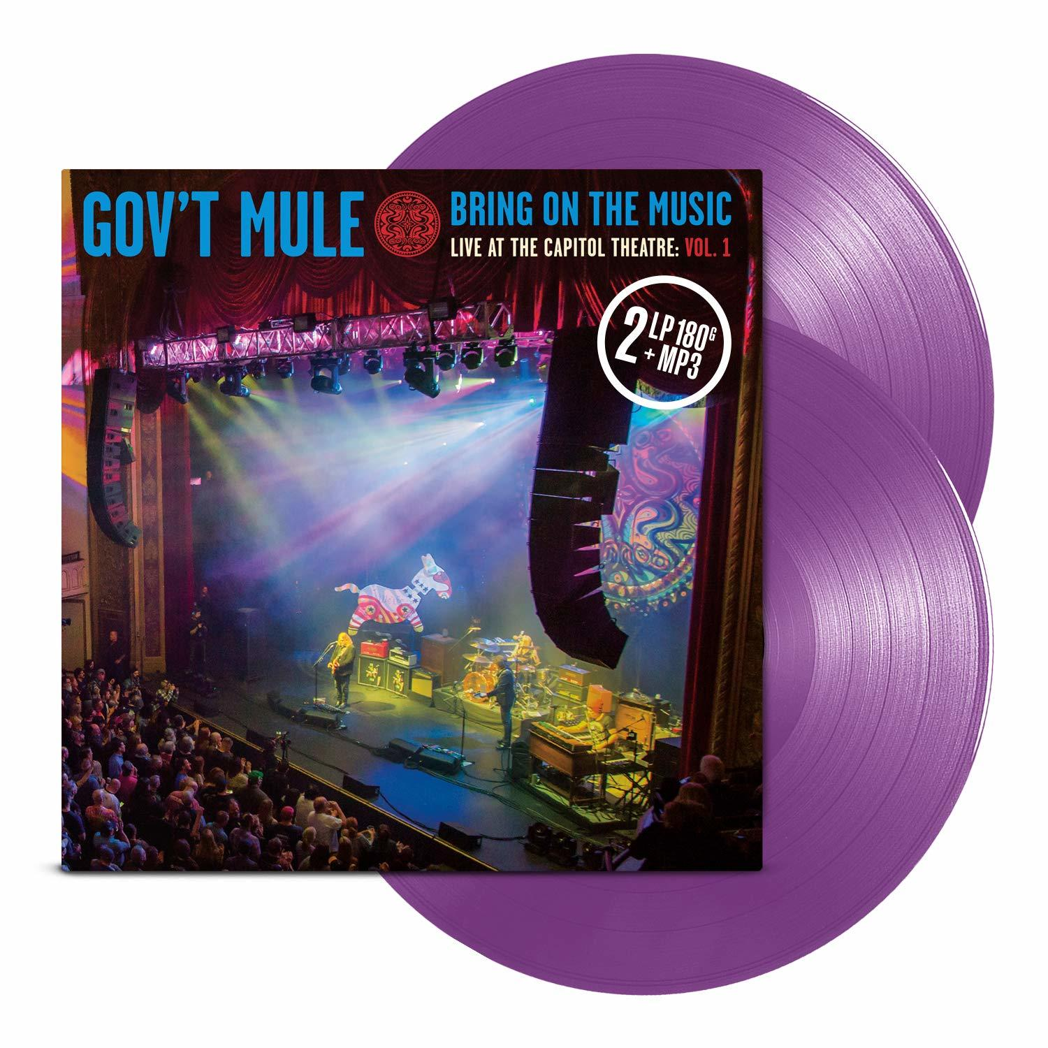 Gov't Mule Albumcover mit Bühnenfoto und lila Vinylplatten.