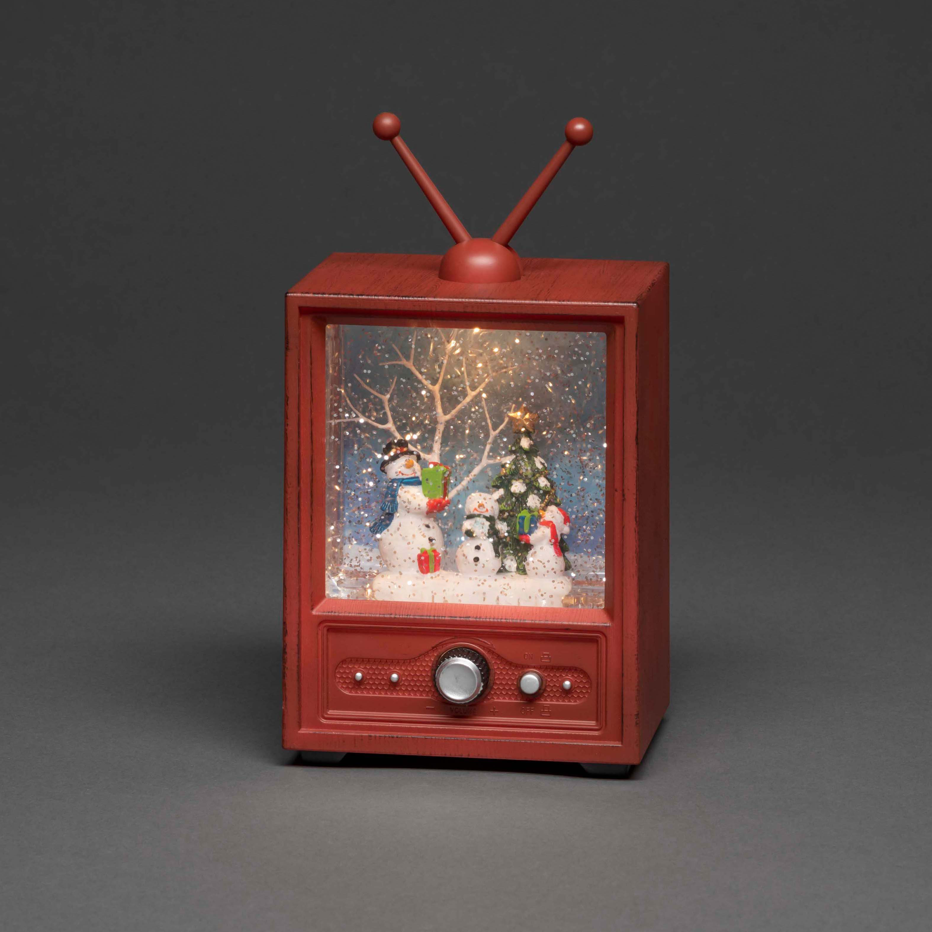 Eine weihnachtliche Schneekugel in Retro-TV-Form mit Schneemännern.