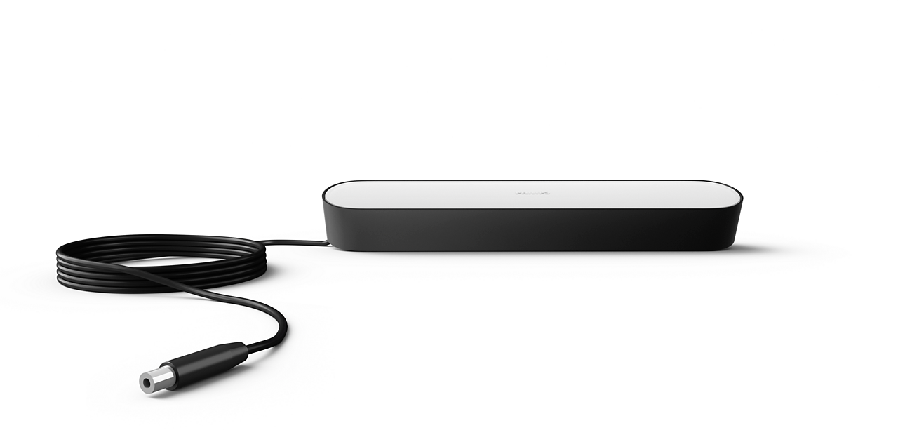 A black and white Philips Hue light bar with a black cable.