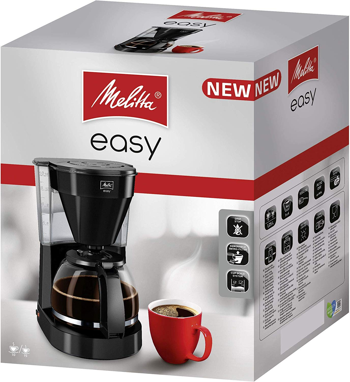 Macchina da caffè e una tazza rossa con caffè davanti a una scatola con il marchio.