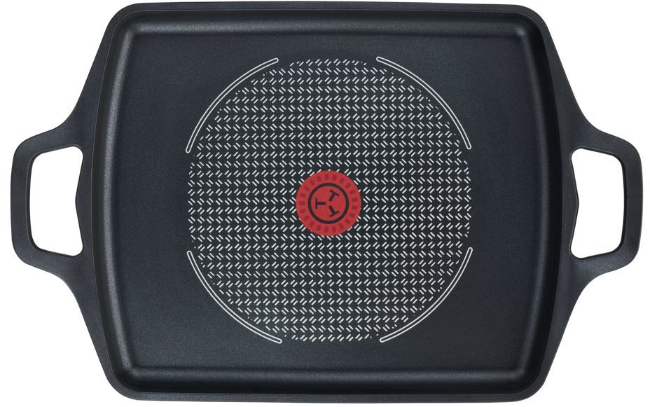 Plancha negra con diseño circular blanco y centro rojo, con asas, vista superior.