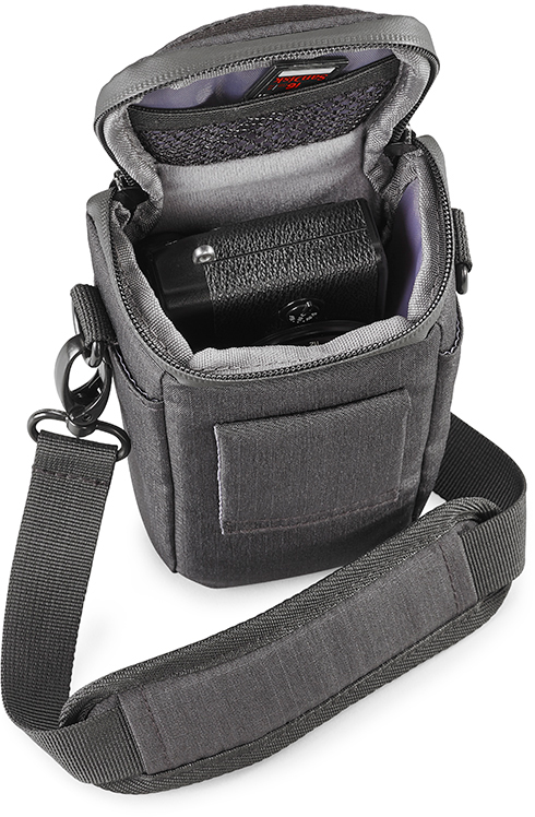 A dark gray camera bag is open, revealing a black camera inside and a strap.