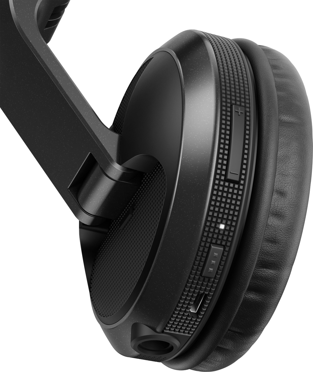 Un casque noir avec des commandes de volume et un port. Le casque est incliné.