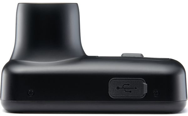 A black charging base with a USB port on the side.
