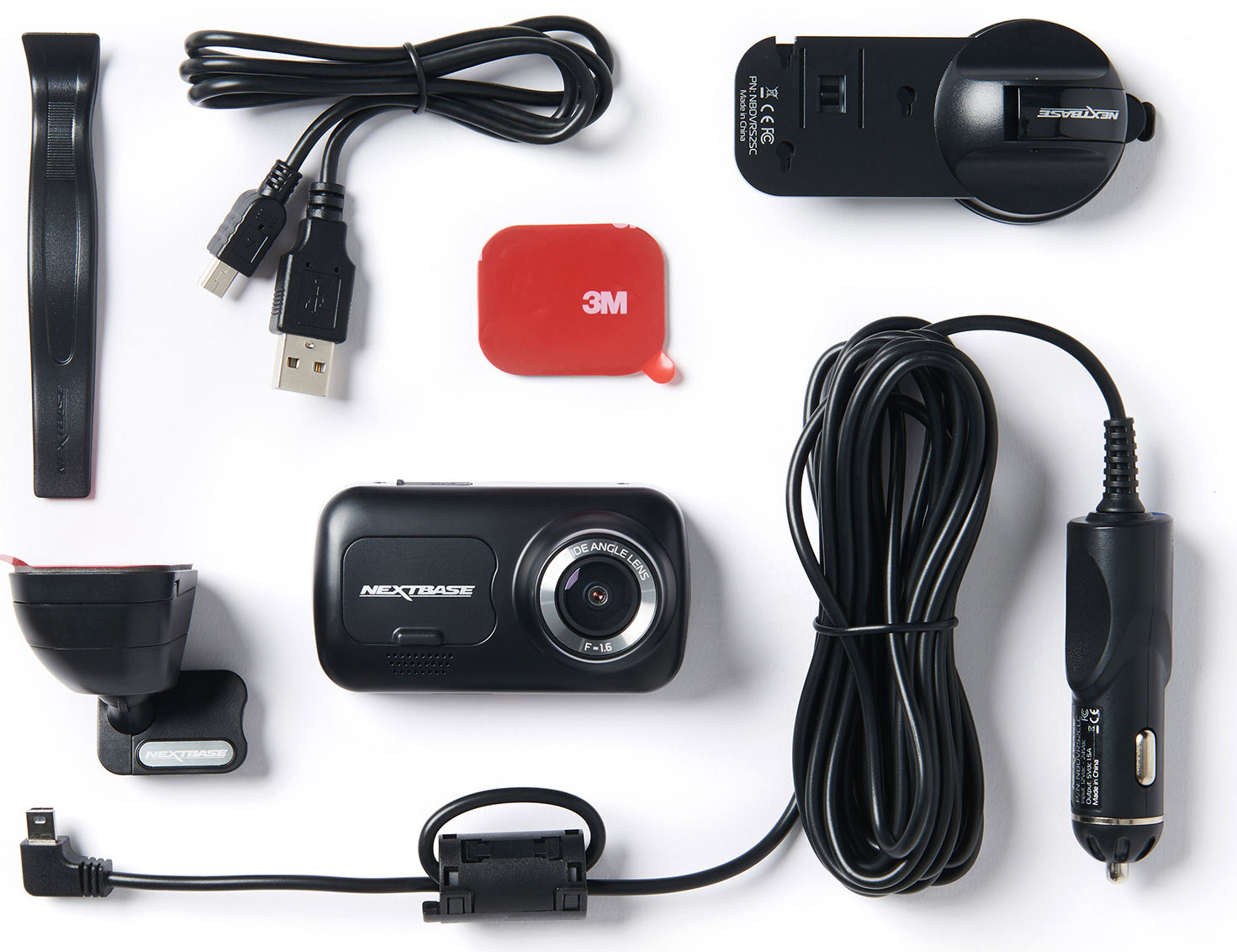 A dashcam kit with various components, including a camera, cables, and mounting hardware, all on white.