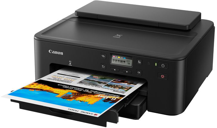 Canon Pixma printer printing a document with color images.