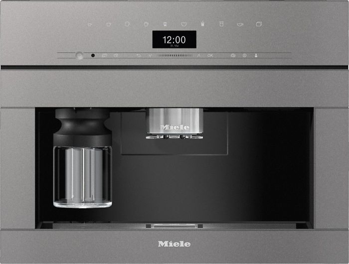 Eingebauter Miele Kaffeeautomat. Es hat ein Display mit der Uhrzeit und einen Kaffeeausgabeschacht.