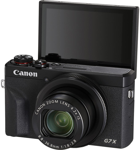 Fekete Canon G7X kamera felhajtott képernyővel, a lencsét és a vezérlőket mutatva.