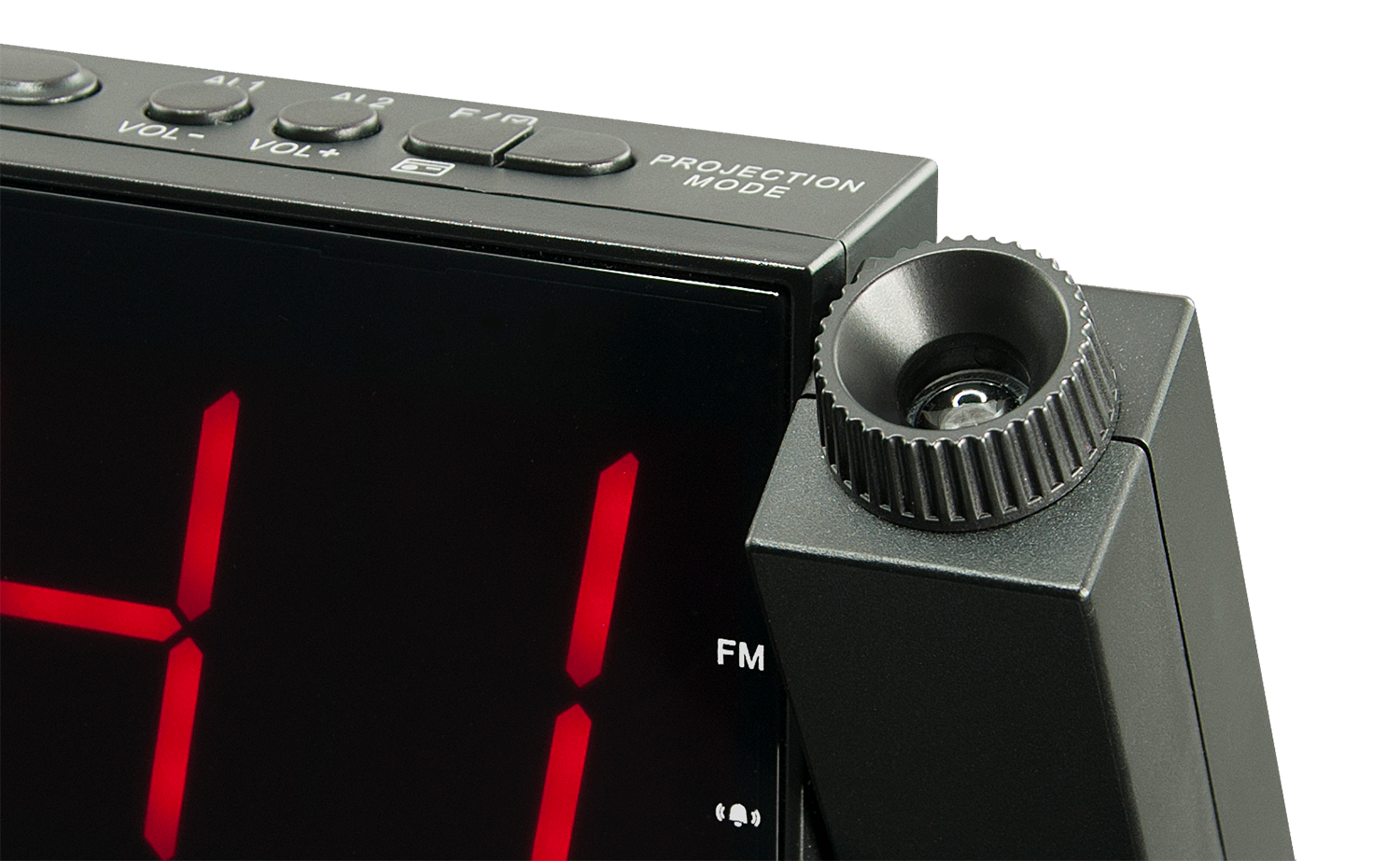 Close-up of a black digital alarm clock. Red numbers are displayed, with a projection mode detail.