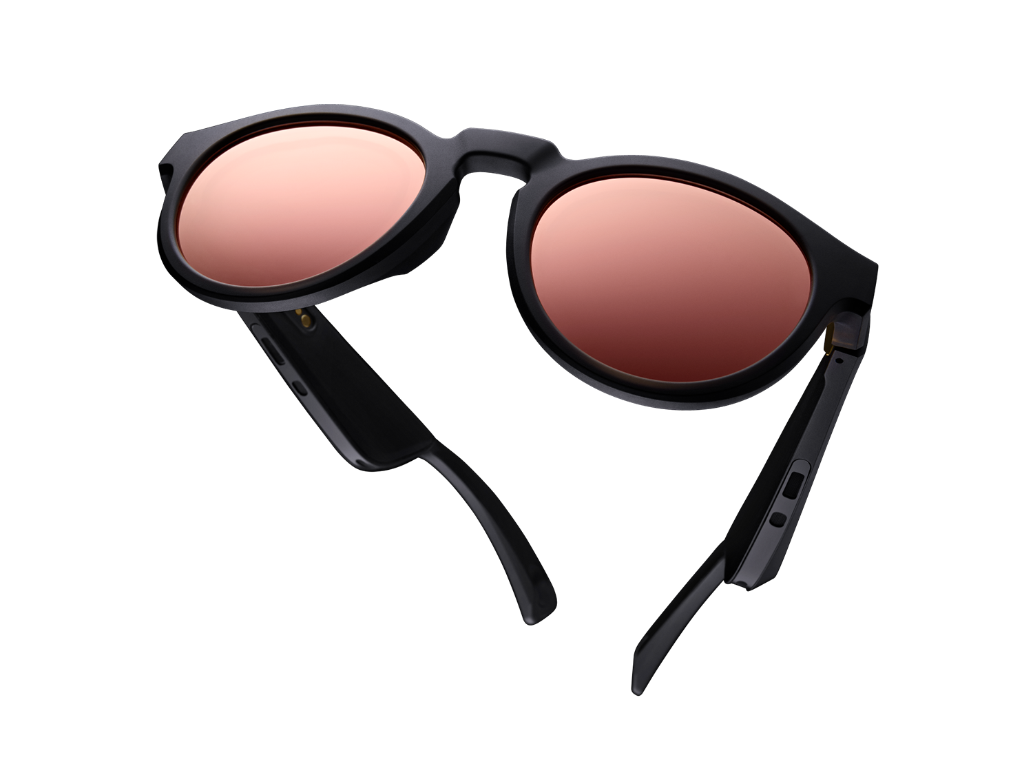 Black sunglasses with rose-tinted lenses, open, on a black background.
