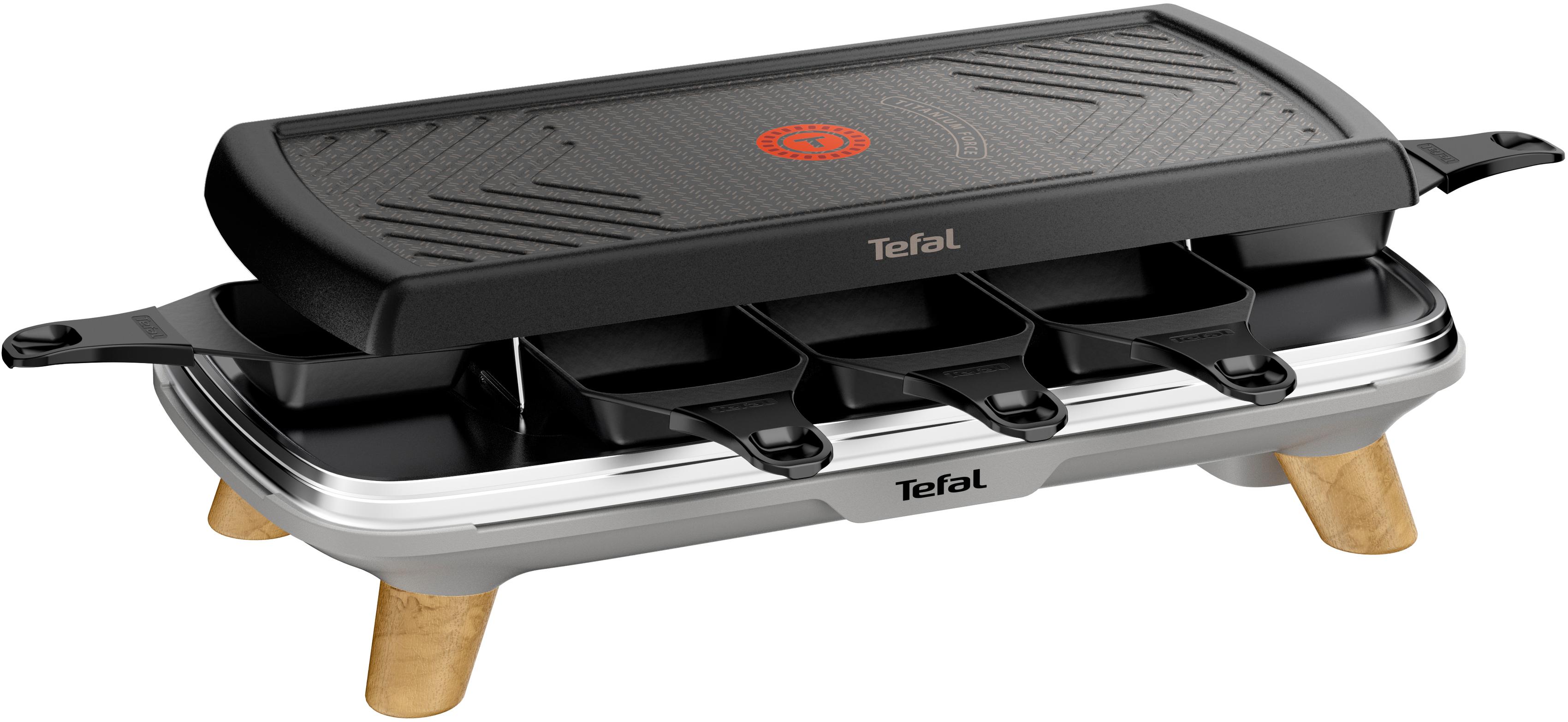Schwarzer Tefal Raclette-Grill mit drei kleinen Pfannen und einer Kochfläche. Holzbeine sichtbar.