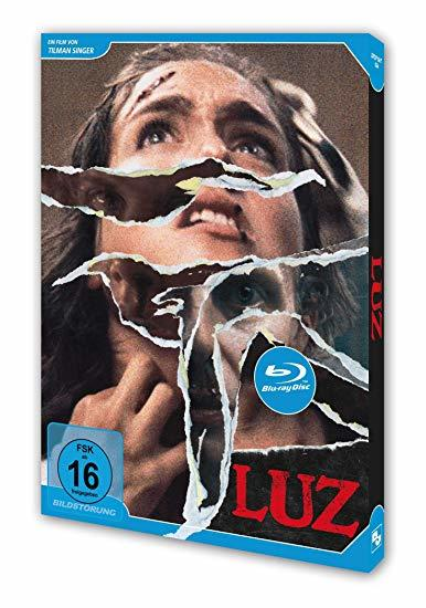 Blu-ray-Cover mit zerrissenem Frauengesicht und dem Titel LUZ.