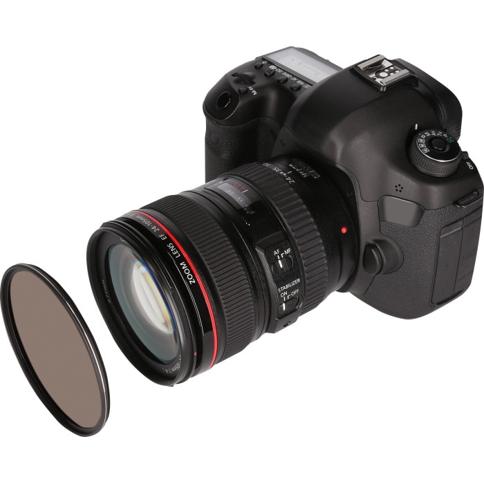 A black DSLR camera with a zoom lens and a circular filter. White background.