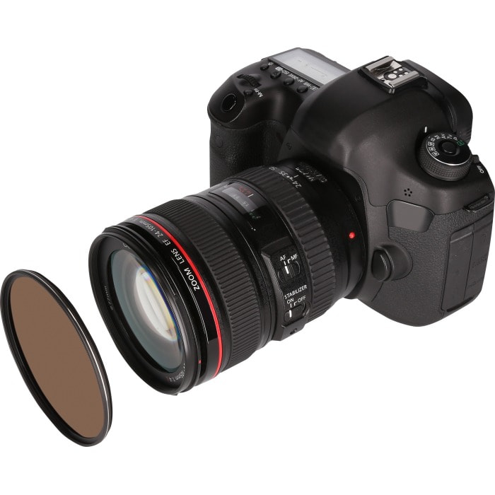 Black DSLR camera with lens and a brown filter.